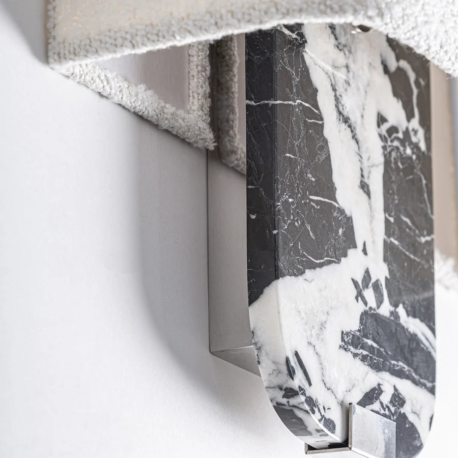 Detalle en ángulo del Aplique de Pared Nailhac sobre la pared, con la veta blanca del mármol negro y el herraje de hierro plata