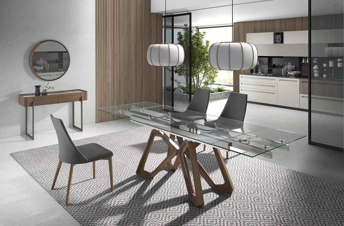 Mesa de Comedor Extensible 1122 extendida en un comedor abierto a la cocina, con sillas grises y alfombra geométrica